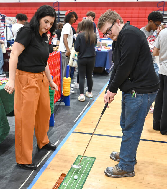 <p>Pittston Area junior James Klein tries his luck at putting for a free gift at the Rycor Heating & Cooling booth during Pittston Area’s Career Exploration Day on Friday, May 1.</p>
<p>Tony Callaio | For Sunday Dispatch</p>