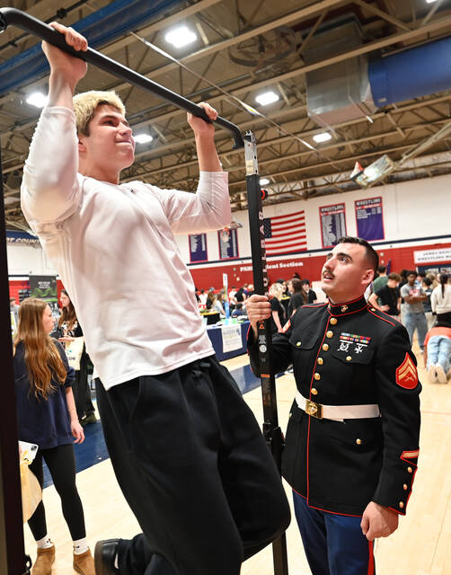 <p>Pittston Area junior Aiden George does pull-ups under the careful eye of Cpl. Hunter Mastrocovi, of the U.S. Marines, at Pittston Area’s Career Exploration Day on Friday.</p>
<p>Tony Callaio | For Sunday Dispatch</p>