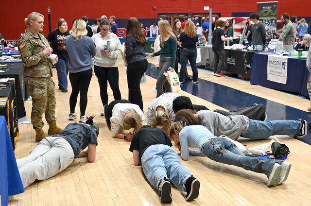 <p>These Pittston Area students attempt to plank while U.S. Army Staff Sgt. Yvone Kuncikowski, left, looks on.</p>
<p>Tony Callaio | For Sunday Dispatch</p>