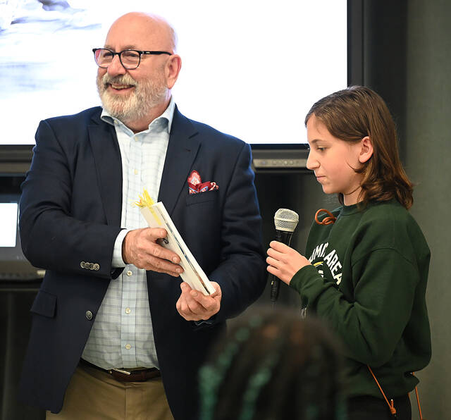 <p>Author David Parmelee asked Wyoming Area Intermediate Center student Hayley Bioxham to read a poem from his latest book.</p>
<p>Tony Callaio | For Sunday Dispatch</p>
