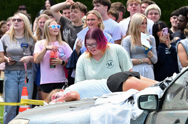 <p>One of the mock car crash ‘victims’ stands over her friend, who ‘died’ going through the windshield of the car at Pittston Area.</p>
<p>Tony Callaio | For Sunday Dispatch</p>