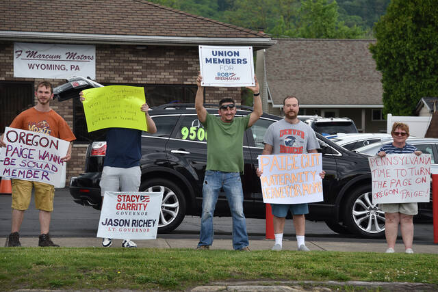 <p>People hold signs protesting Gov. Josh Shapiro and Scranton Mayor Paige Cognetti during their campaign event on Wednesday at The Avenue Restaurant and Catering in Wyoming.</p>
<p>Liz Baumeister | Sunday Dispatch</p>