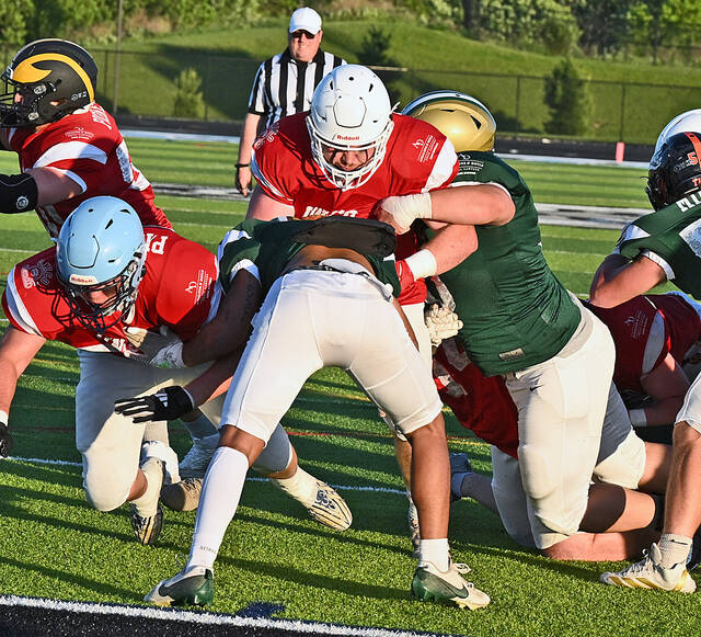 132389236_web1_2026-UNICO-Game-1
UNICO Pioneers Brody Spindler, center red shirt, of Pittston Area, picks up where he left off last fall by bulldozing his way to a one-yard touchdown for the first score of the night of the 75th UNICO All-Star game at Wilkes-Barre Areas home field on Thursday evening.
Tony Callaio | For Times Leader