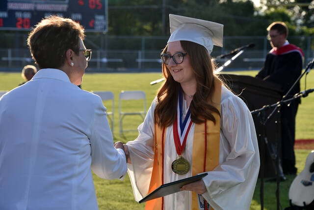 <p>Emily Shovlin, one of five valedictorians of the Class of 2026, accepts her diploma from Pittston Area School Board Vice President Rosanne Ricotta during the school’s 60th commencement ceremony on Friday, June 5.</p>
<p>Liz Baumeister | Sunday Dispatch</p>