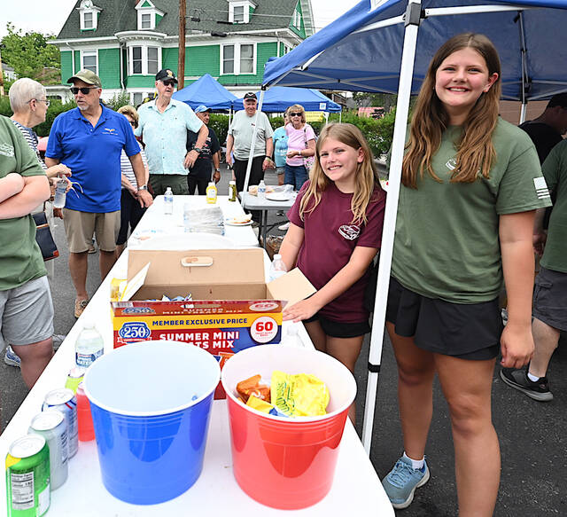 <p>Chloè Kelly, center, and her sister Grace, right, of Wyoming Area Catholic Builders Club, volunteered at the food tent for the Vettes for Vets car show.</p>
<p>Tony Callaio | For Sunday Dispatch</p>