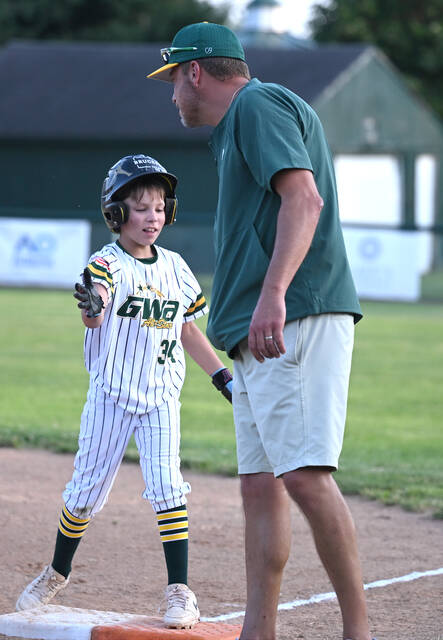 <p>In a father-son moment, Greyson Speicher is congratulated by his father, Eric, after hitting an RBI to drive in the tying run against KFF during extra innings.</p>
<p>Tony Callaio | For Sunday Dispatch</p>