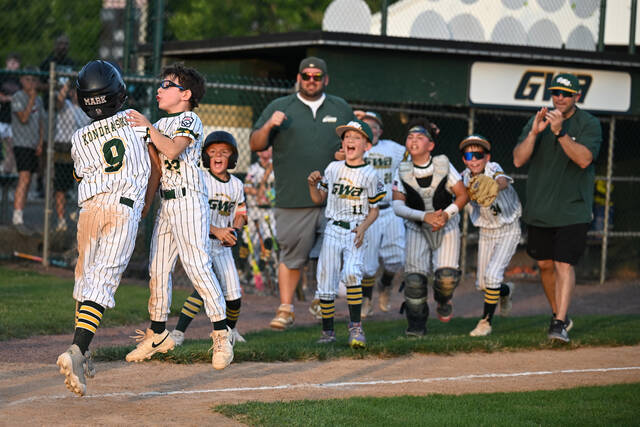 132471725_web1_GWA-KFF-Minors-6
Mark Kondraski (9) is greated by Gavin Shandra ( 22) and the rest of the GWA team after Kondraski stole home for the winning run against KFF in 8-innings at West Pittston Little League on Tuesday night.
Tony Callaio | For Sunday Dispatch