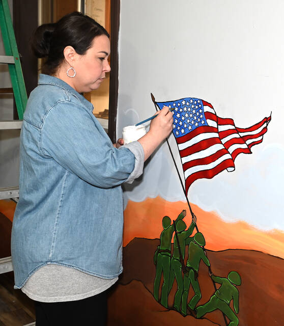 <p>Liz Baldassari, artist and Arts Council member, puts the finishing touches on the American Flag mural at the Pittston American Legion Post 477.</p>
<p>Tony Callaio | For Sunday Dispatch</p>