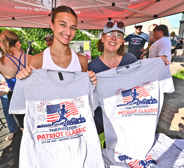 <p>Pittston Patriot 5K Classic Walk/Run volunteers Brooke Kroptavich, left, and Jessica Matushek sold t-shirts prior to the inaugural race.</p>
<p>Tony Callaio | For Sunday Dispatch</p>