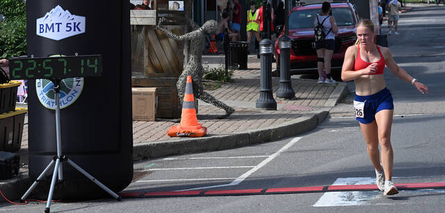 <p>The first overall female winner, Kira Pomrinke, of Dallas, glances at the timing clock as she finishes in the first annual Pittston Patriot Classic 5K race on Saturday.</p>
<p>Tony Callaio | For Sunday Dispatch</p>